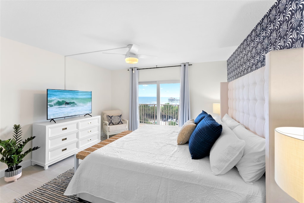 Spacious master bedroom with ocean views, plush bedding, and elegant decor.
