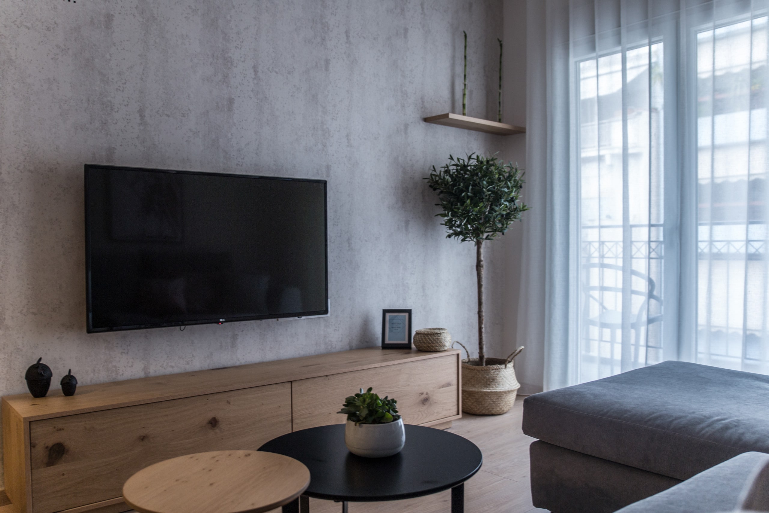 The living room has a comfortable sofa bed with a big flat smart TV and a dining table bar. From the big window door you have access to the balcony of the apartment where you can look down to the road. 

