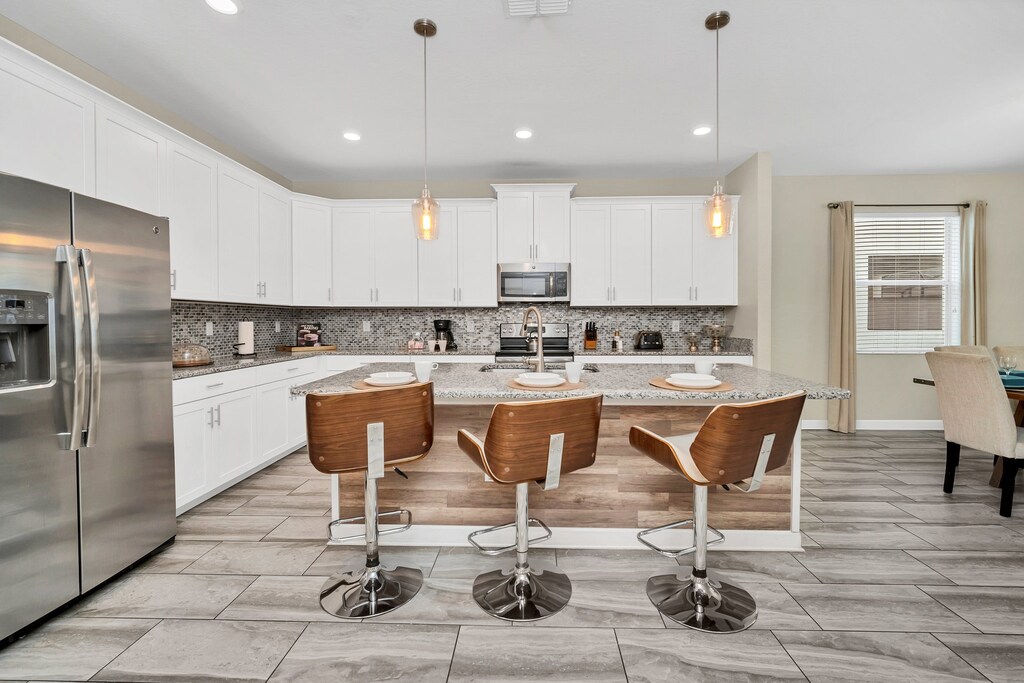 The kitchen features a sleek and functional counter table, ideal for casual dining, meal prep, or enjoying a quick snack in style.