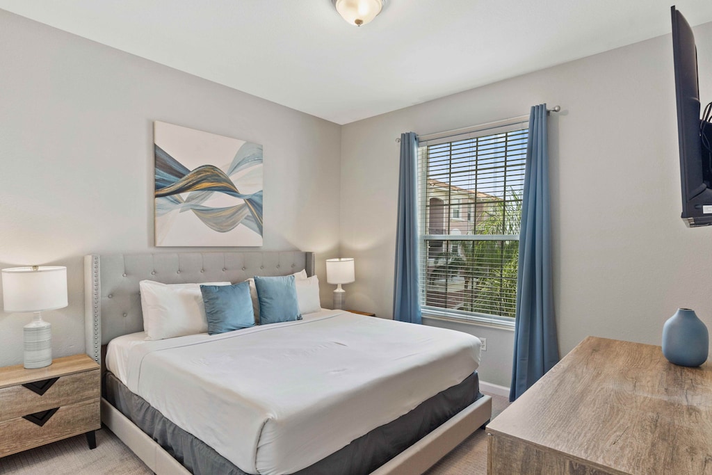 Urban Elegance: Unwind in style in our bedroom, where modern design meets convenience with a sleek Smart TV for a sophisticated stay.