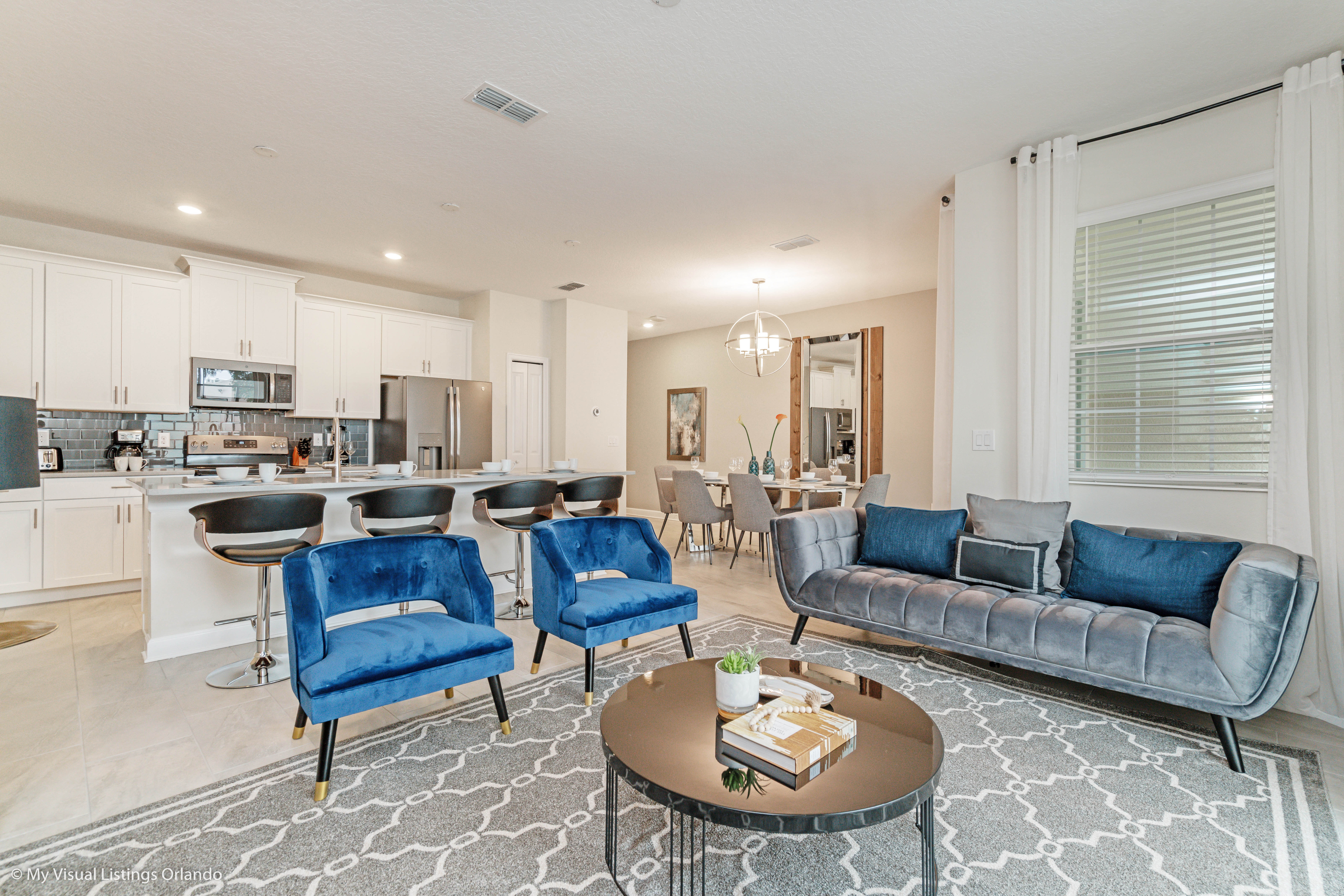 Enchanting Living Area of the Townhouse in Kissimmee Florida - Beautiful living room with an open layout, creating a sense of spaciousness - Thoughtful mix of textures, from plush rugs to tasteful throw pillows