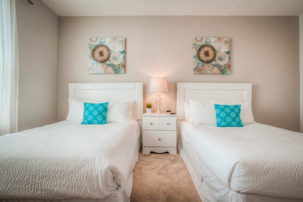 Welcome to the spacious two-bed bedroom at Vista Cay Resort, where relaxation meets style, providing guests with a cozy retreat to unwind and recharge amidst modern comforts and inviting ambiance.
