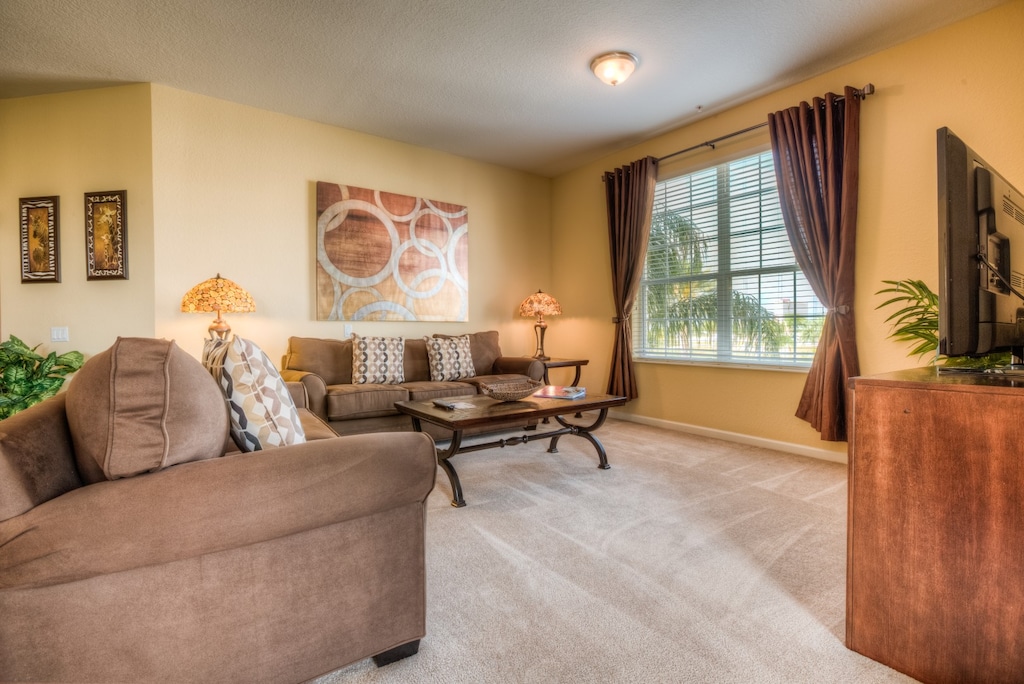 Indulge in luxury at our plush living area in Florida, just moments away from Walt Disney World Resort. Sink into the embrace of comfy sofas, surrounded by well-chosen lighting fixtures that enhance both functionality and charm.