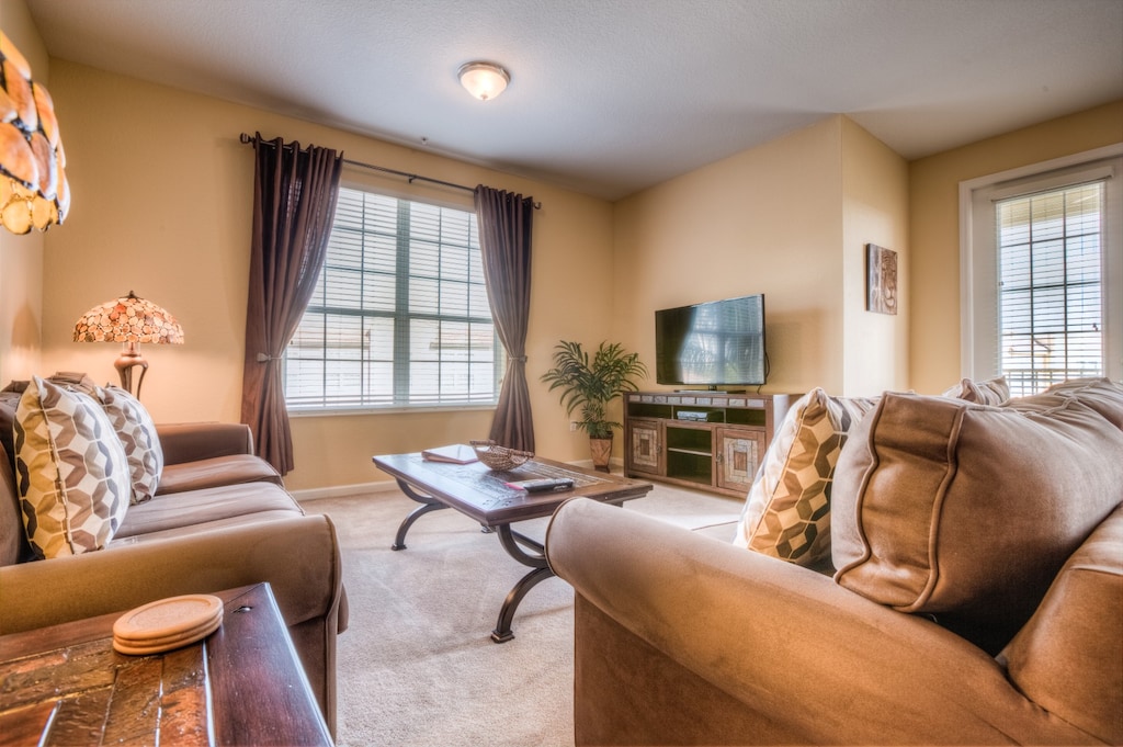 The living room, complete with a sleek TV setup, invites you to unwind and immerse yourself in your favorite shows and movies, creating cherished moments of relaxation and enjoyment.