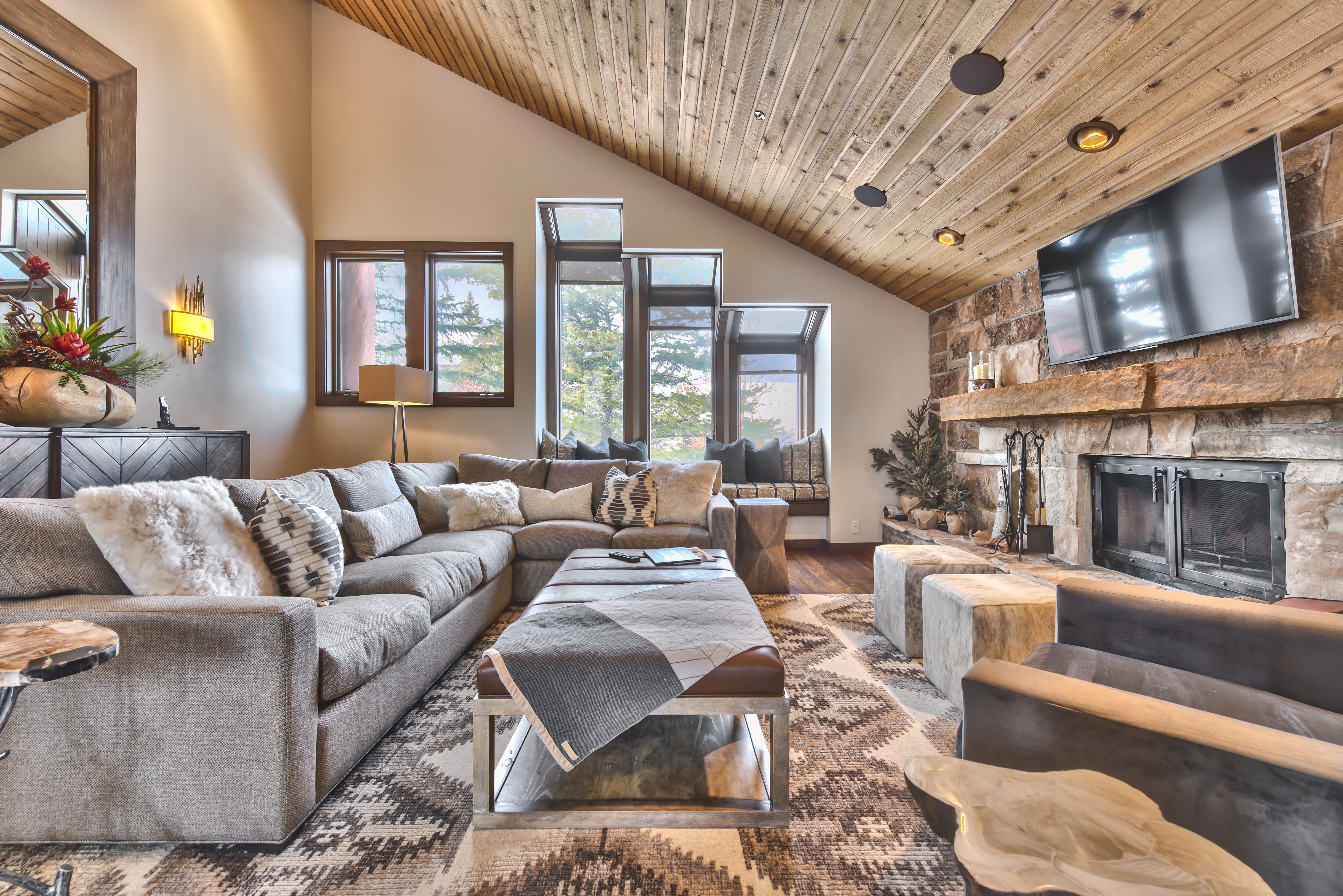 Upper Level Living Room with Cozy Mountain Contemporary Furnishings, a Smart TV and a Gas Assist Wood Fireplace