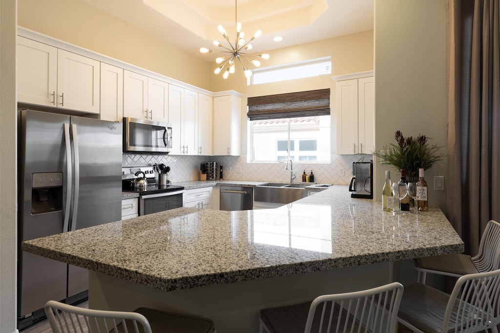 Modern kitchen with additional seating at the counter.