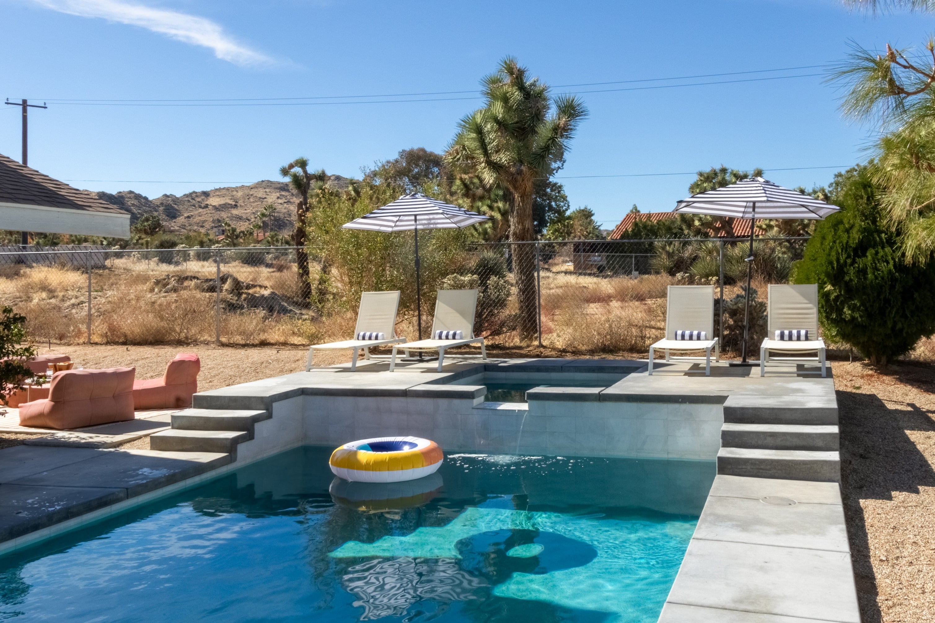Stunning backyard with a private pool, hot tub, and plenty of loungers.