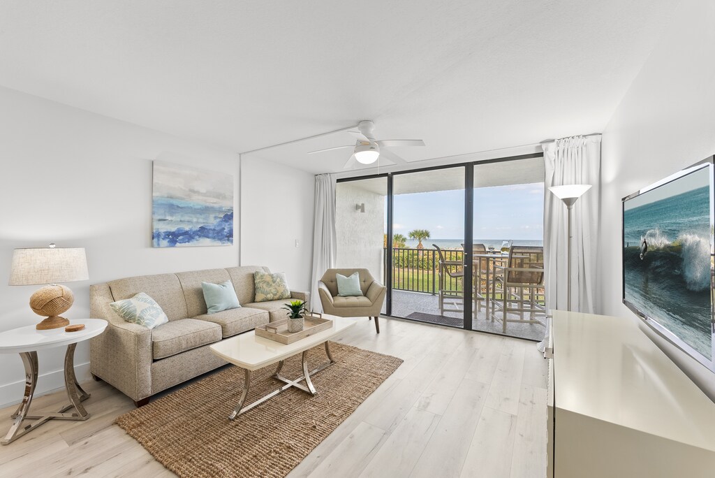 Cozy and inviting living space with comfortable seating and a seamless indoor-outdoor feel.