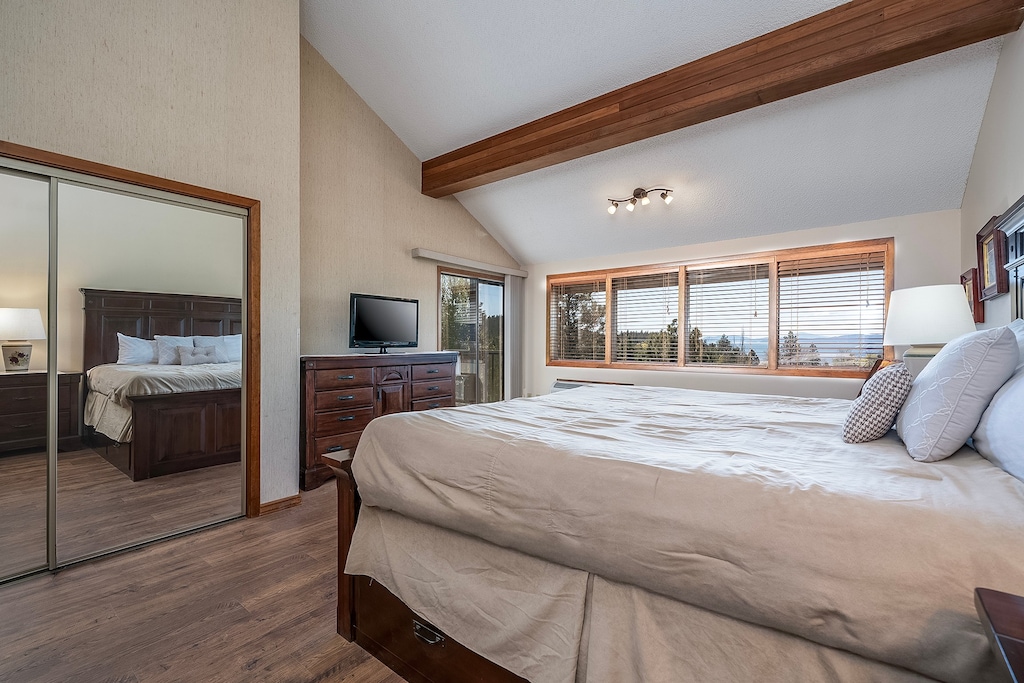 The first bedroom has access to the private balcony | King Bed | Main Level