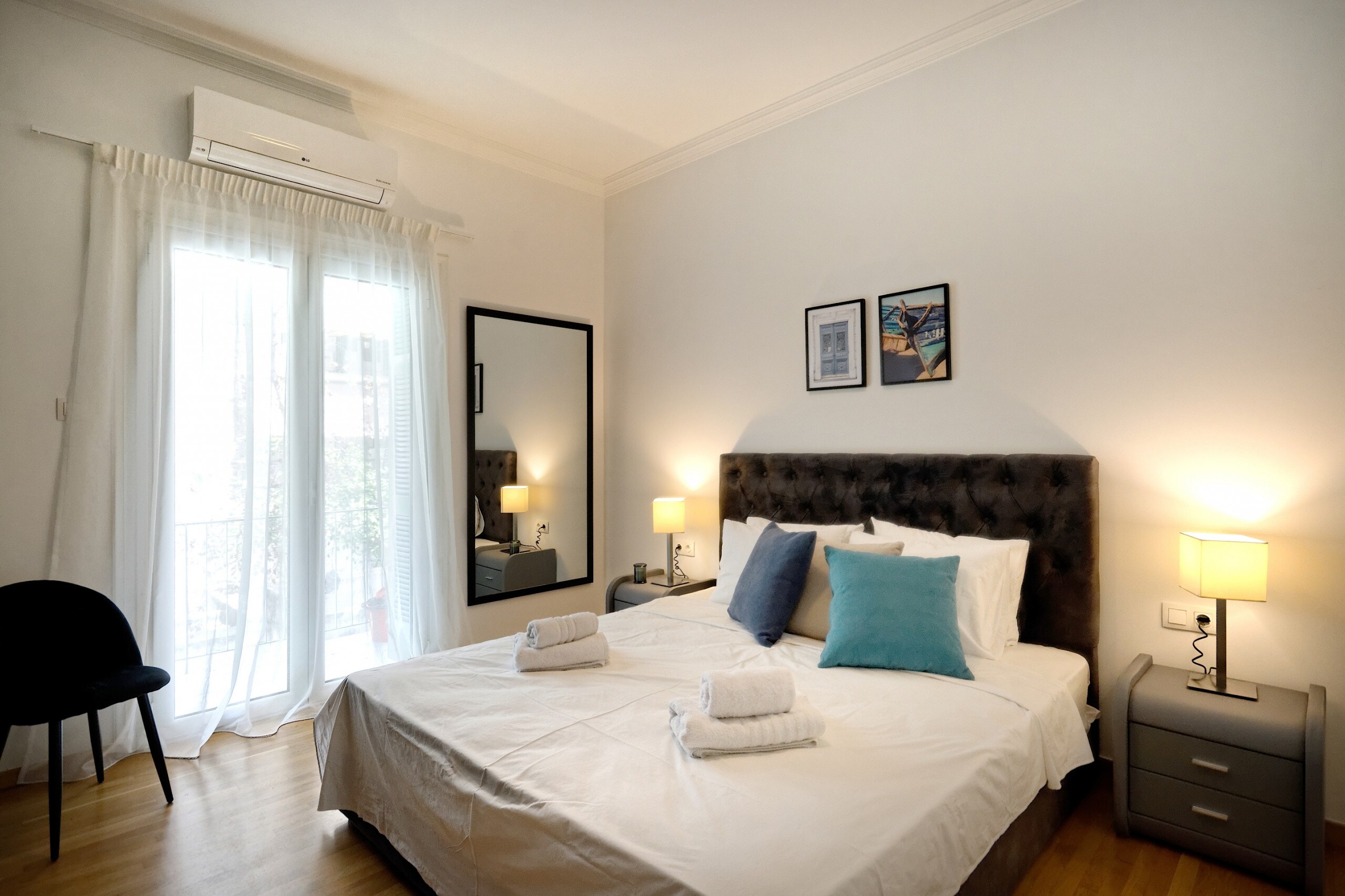 The bedroom is spacious and luminous with a queen bed with a high-quality mattress and beddings and beautiful artwork