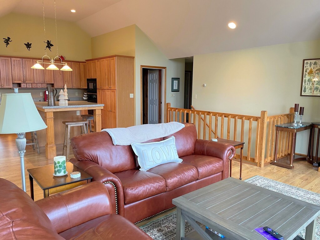 Upper level living area looking to kitchen, stairs, garage, and main level master bedroom