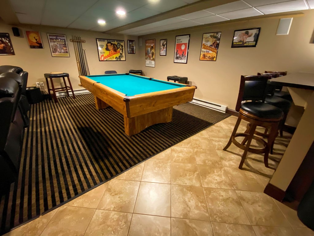 All the comforts with a movie theater room, game tables, and a pool table.
