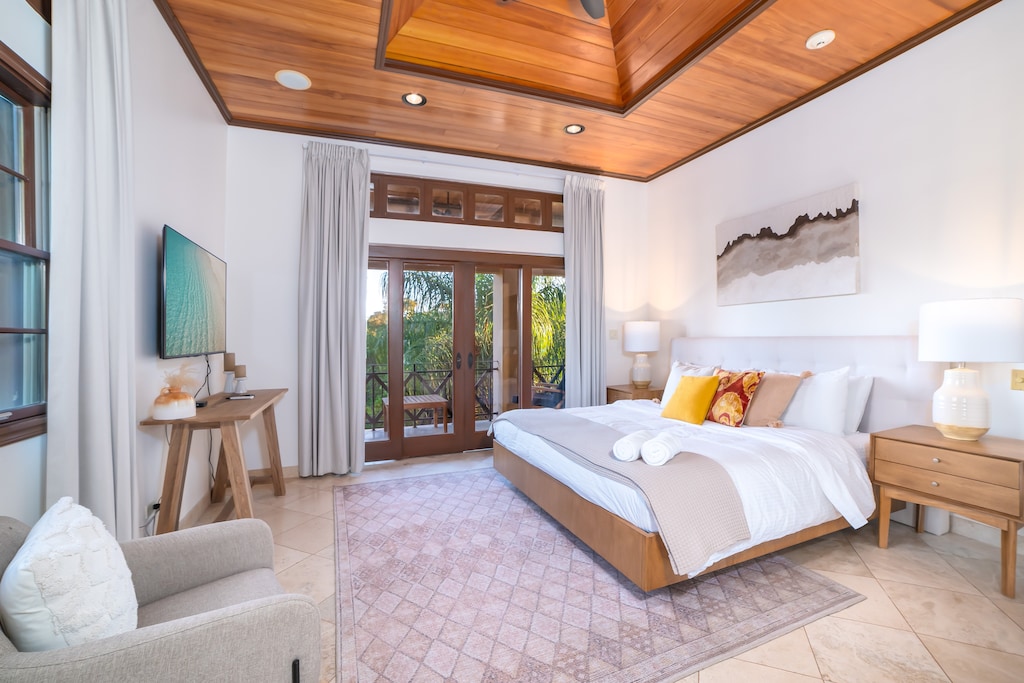 Beautiful Master Bedroom 1 with King Bed, AC, Ceiling Fan, Ensuite bathroom, private balcony, and Smart TV.