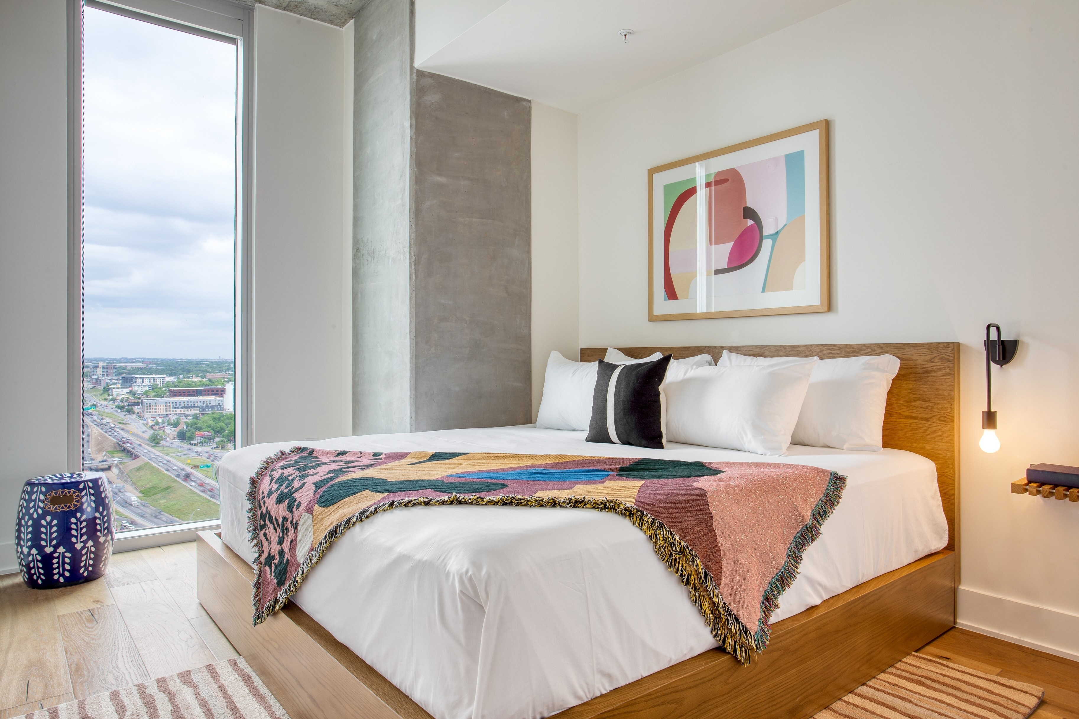 Bedroom features a king bed and floor to ceiling windows.