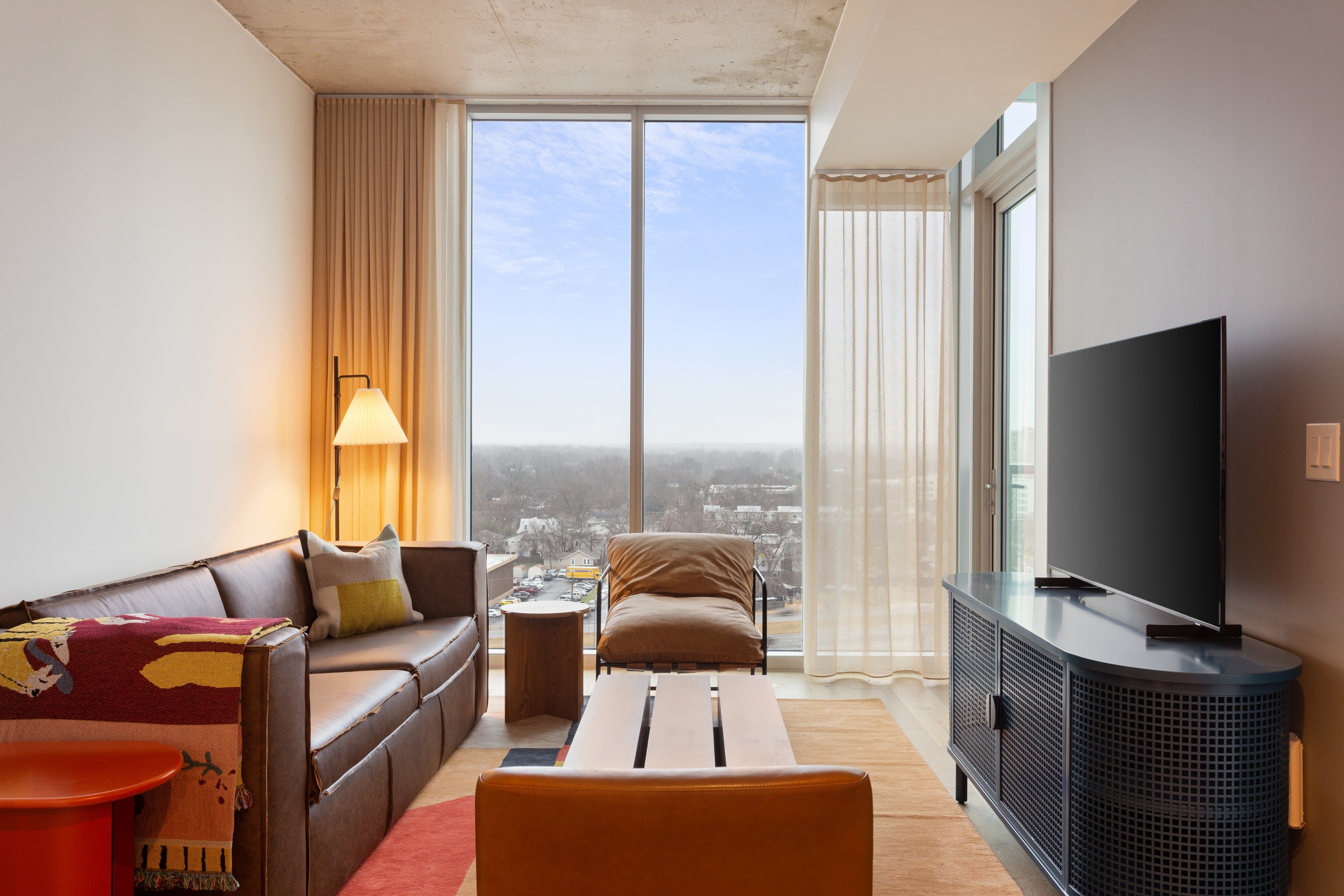 Living room features a contemporary style and floor to ceiling windows for incredible views of Austin.