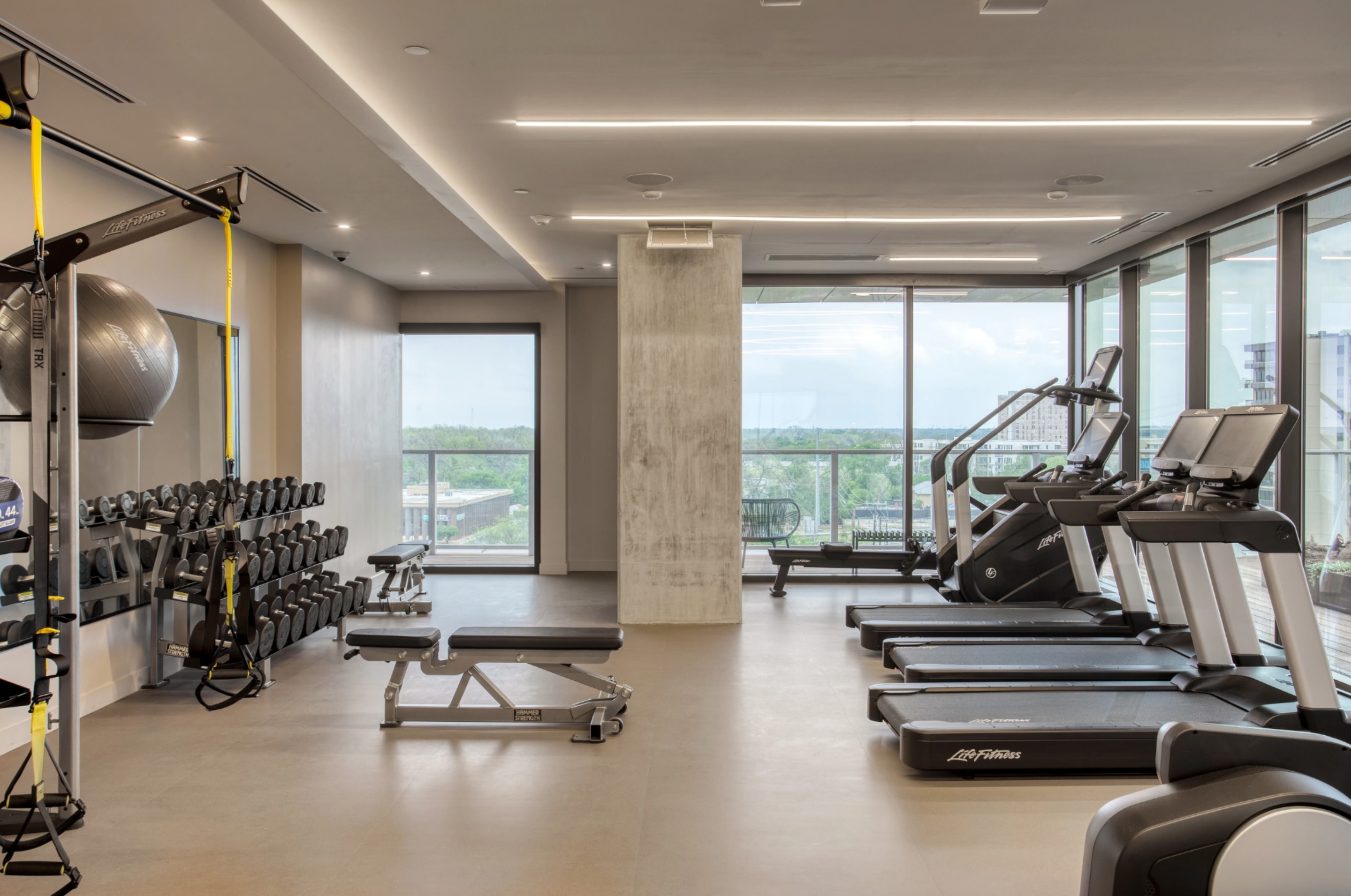 Gym boasts floor to ceiling windows and a corner view.