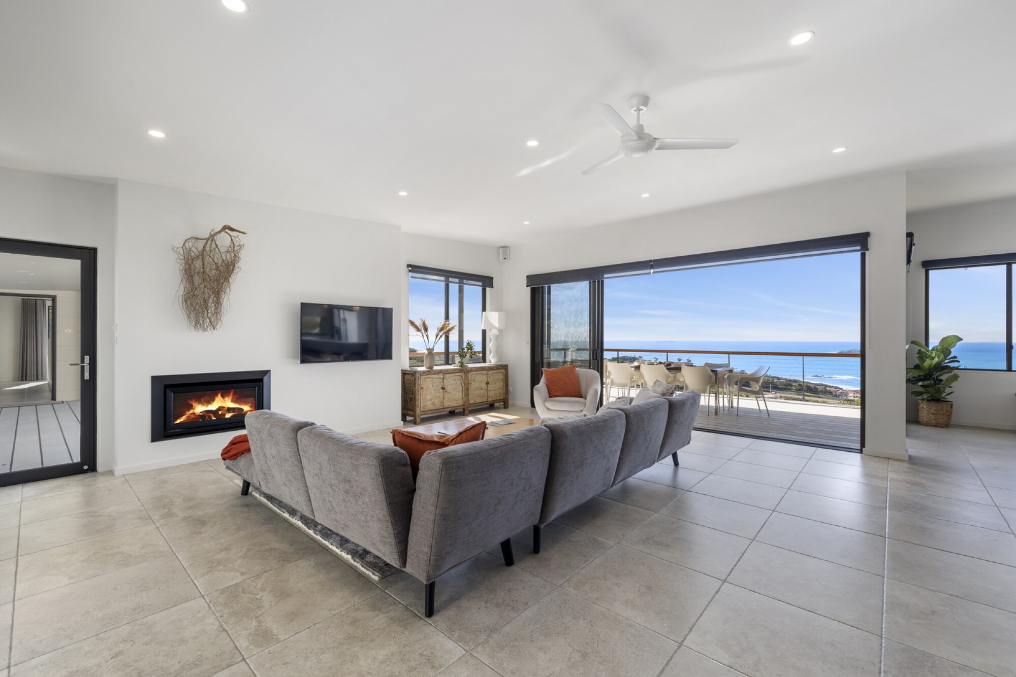 Lounge area with gas fireplace, deck and ocean views