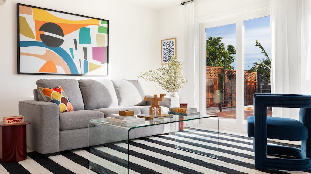 Living room leads to gorgeous outdoor deck and features a pull out sofa.
