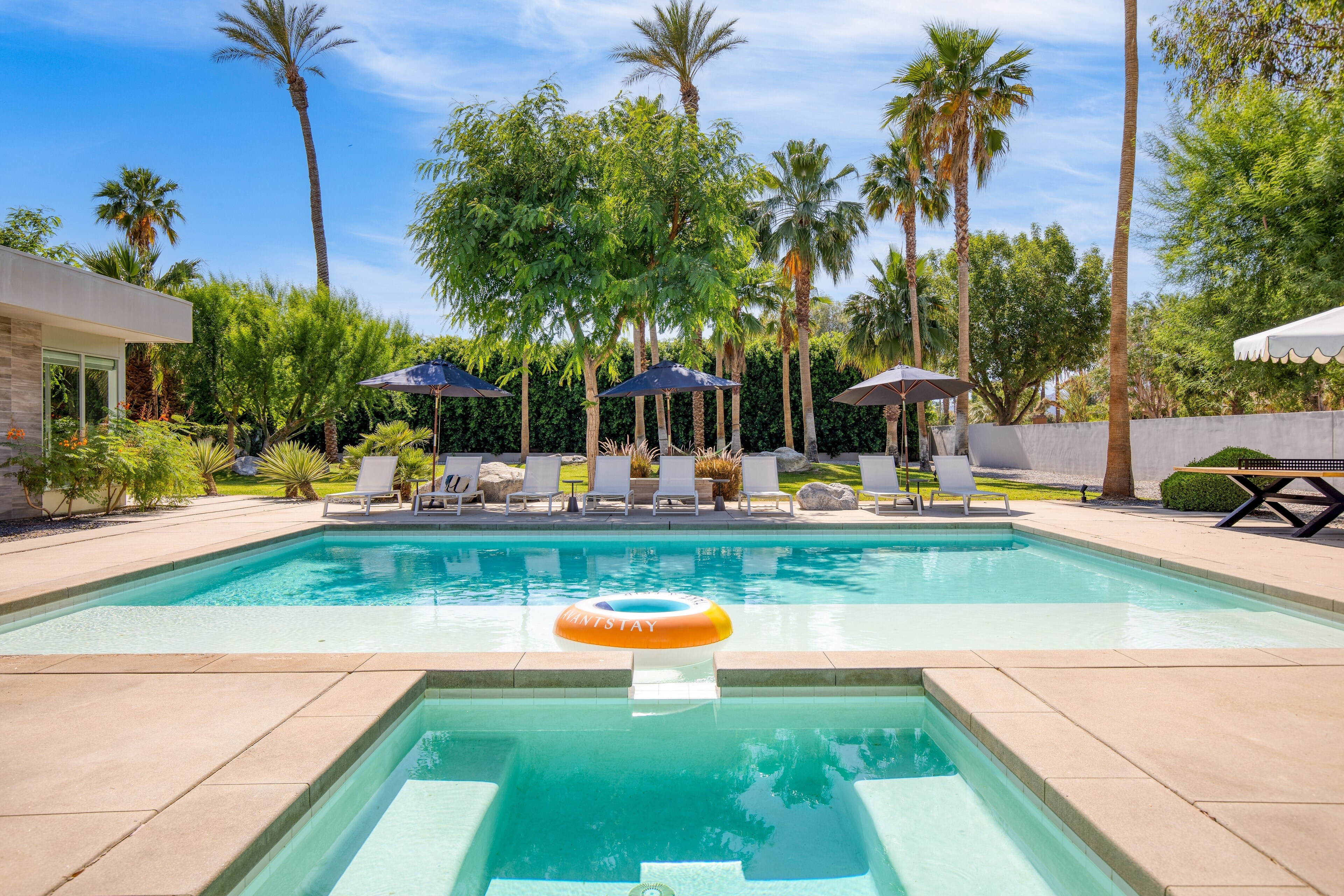 Your spacious backyard oasis features a large pool and private hot tub.