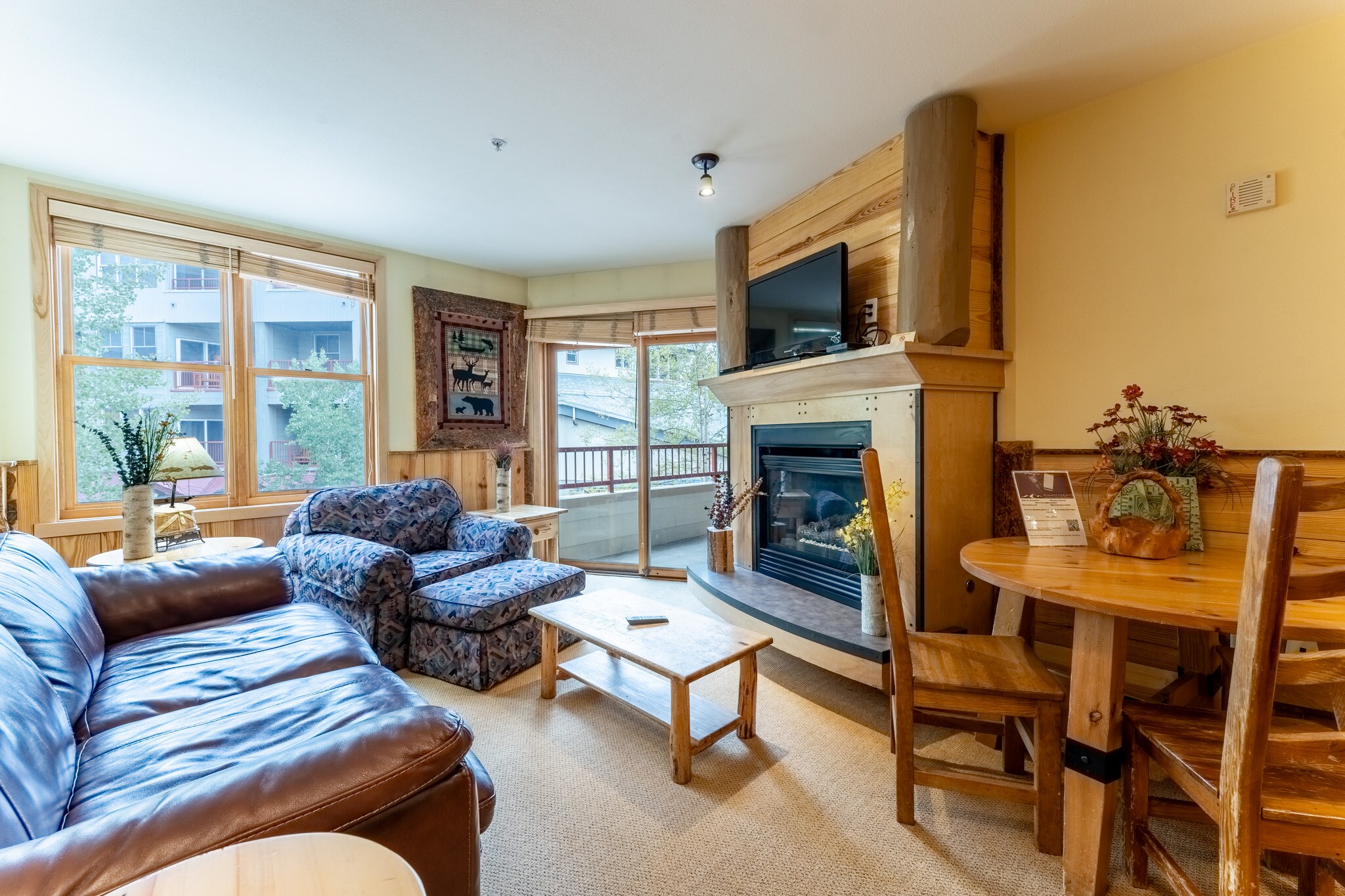 Living area with updated furniture and a gas fireplace.