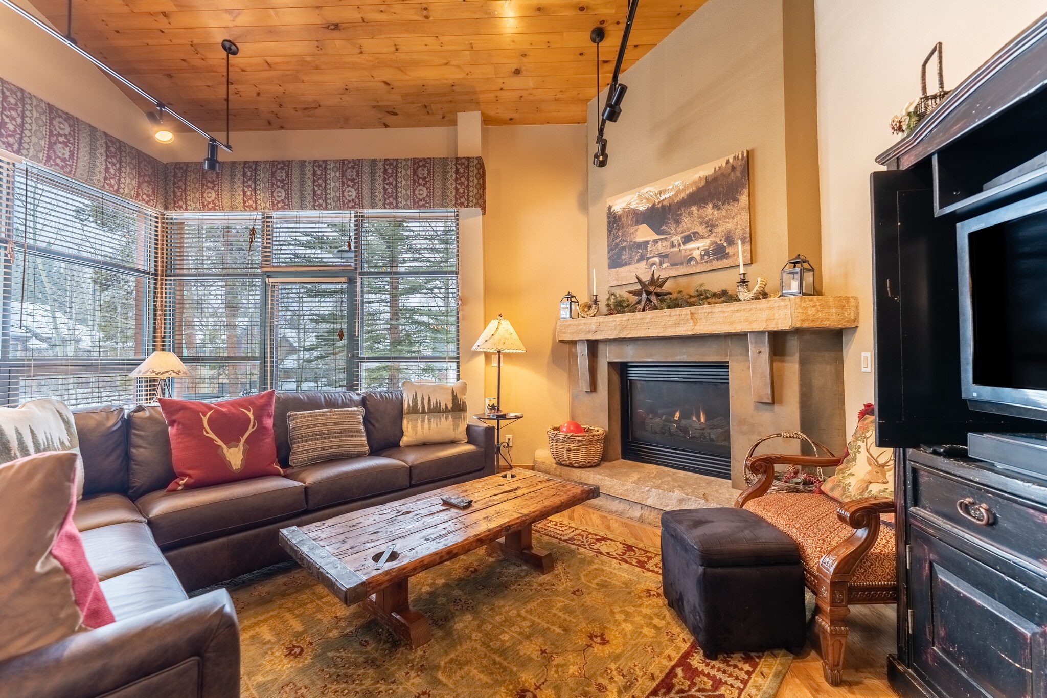 Living area offering cozy furnishings, a gas fireplace and TV.