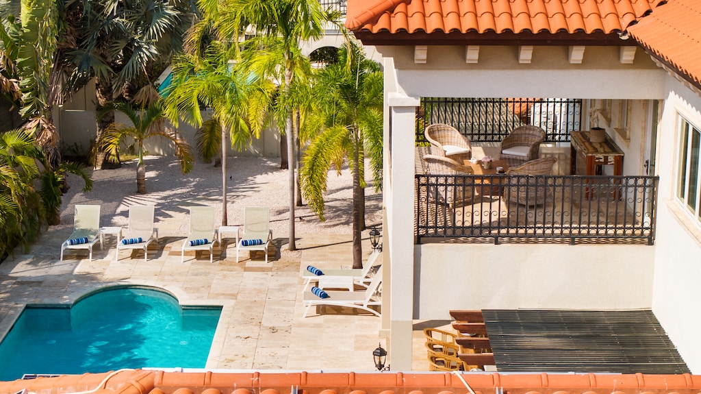Balcony overlooking the pool, offering a perfect vantage point for relaxation.