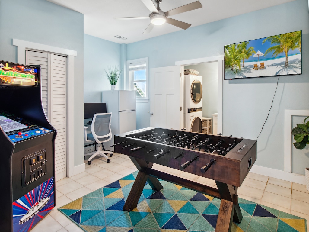 Spend your evenings in the Ground-Level Game Room with the Laundry Room, additional refrigerator, and Arcade Gaming System.