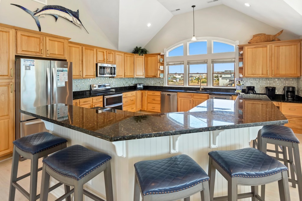 The Kitchen with modern appliances and a counter bar is perfect for your favorite vacation meal.