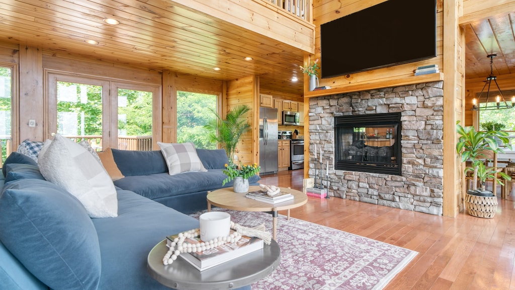 Spacious living room with vaulted ceilings and a fireplace.