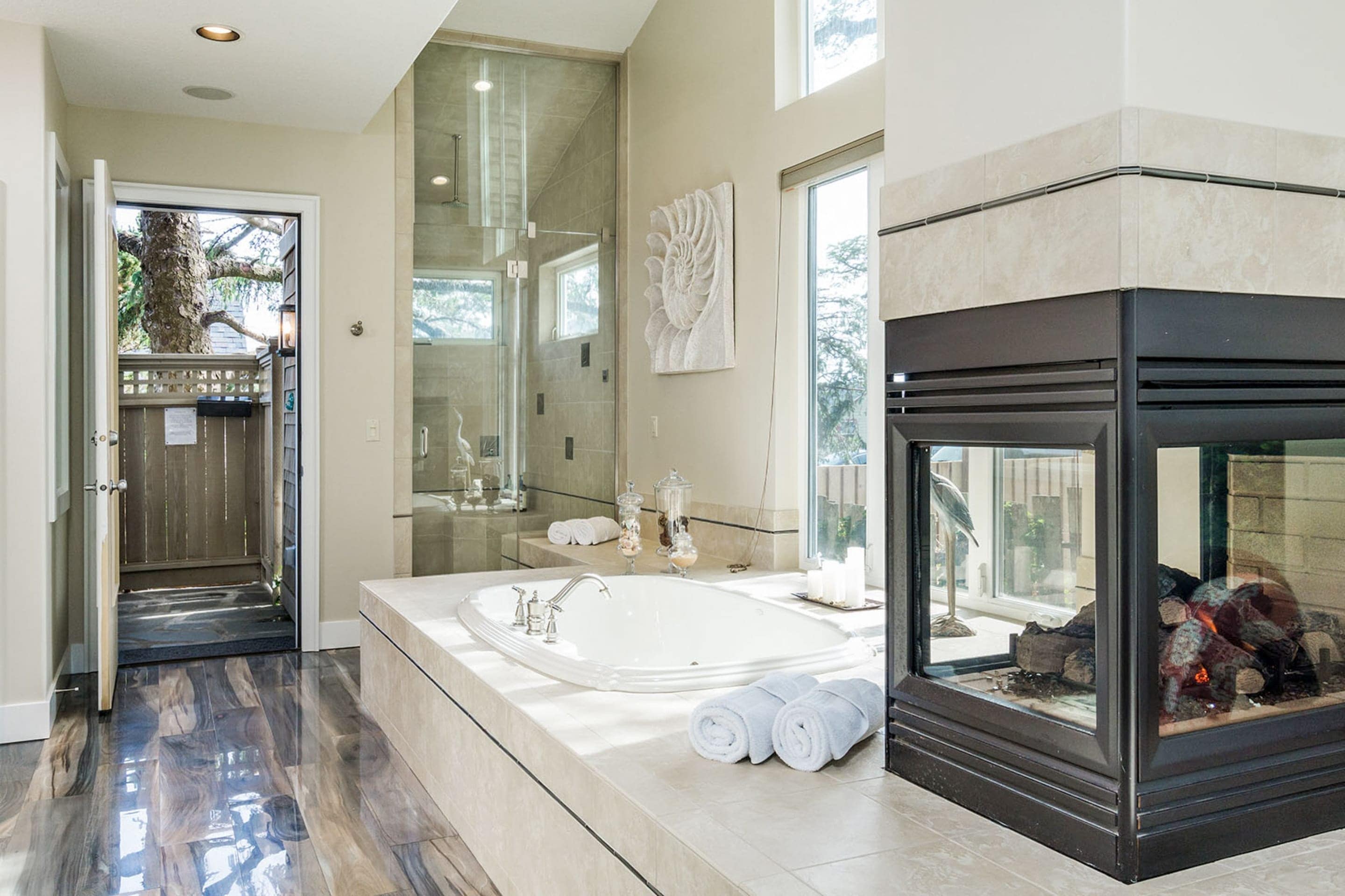 Enjoy a fireside soak and outdoor access directly from the primary ensuite.