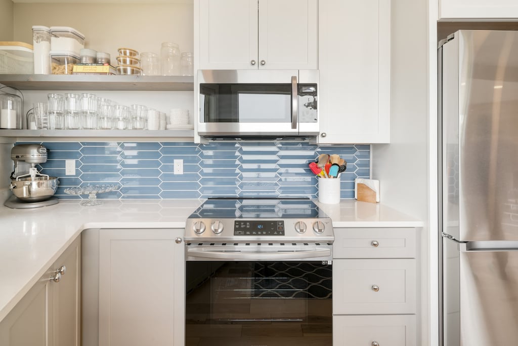Kitchen features a oven, microwave, drip coffee and fridge.