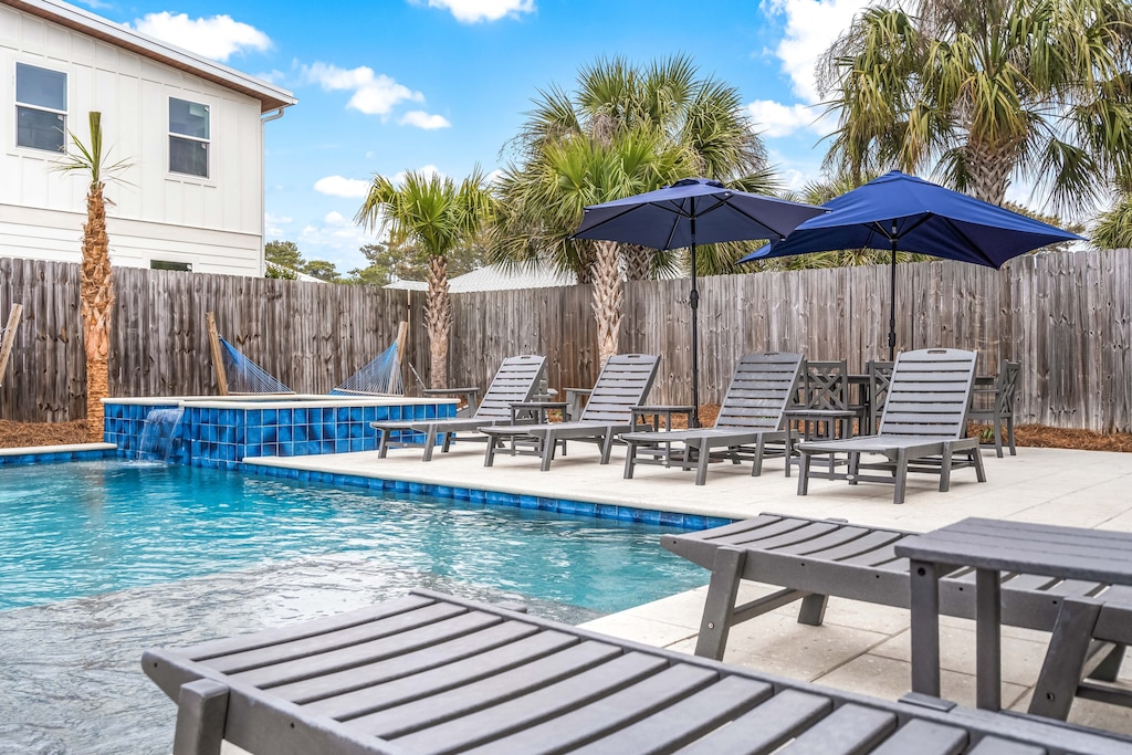 Private pool and hot tub in the backyard.