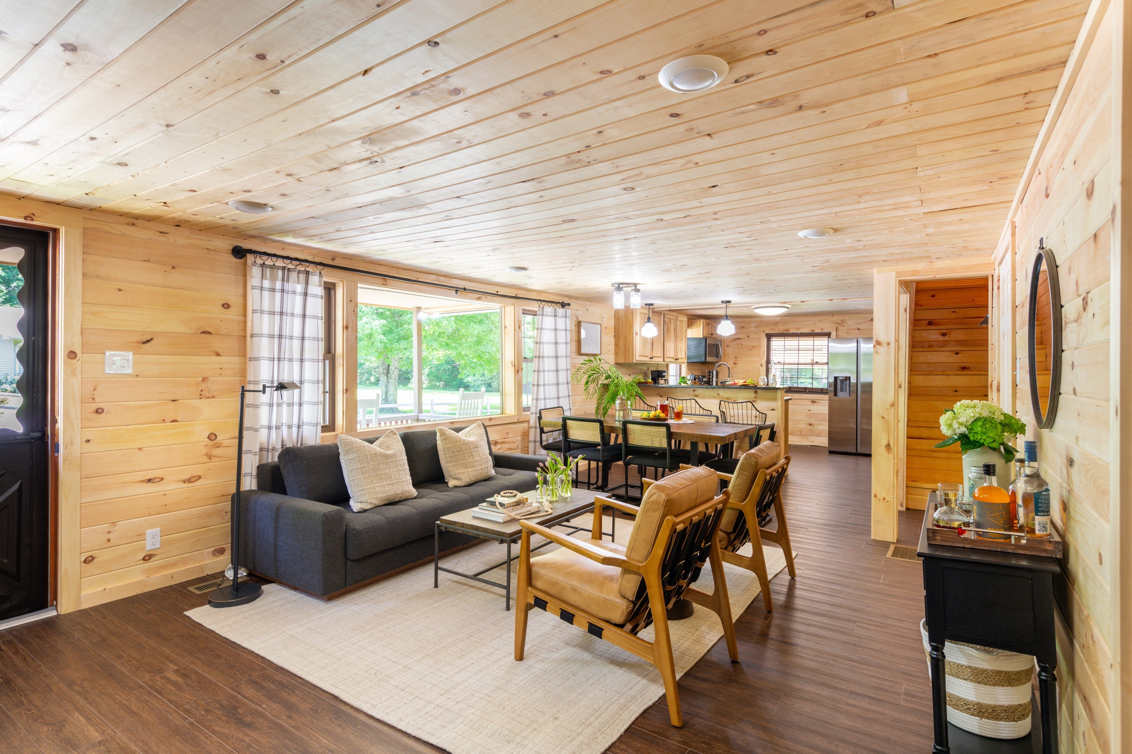 Living room features comfortable seating and a warm yet modern atmosphere.