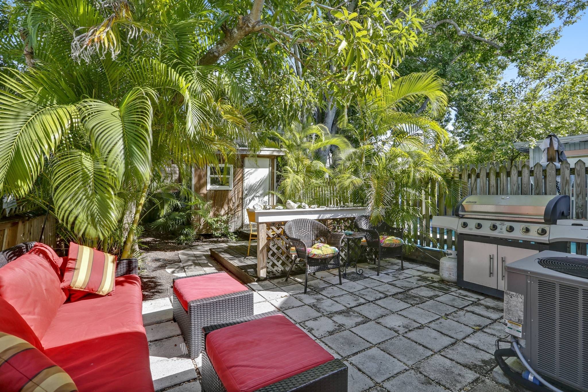 Dreamy backyard oasis with seating area and grill.