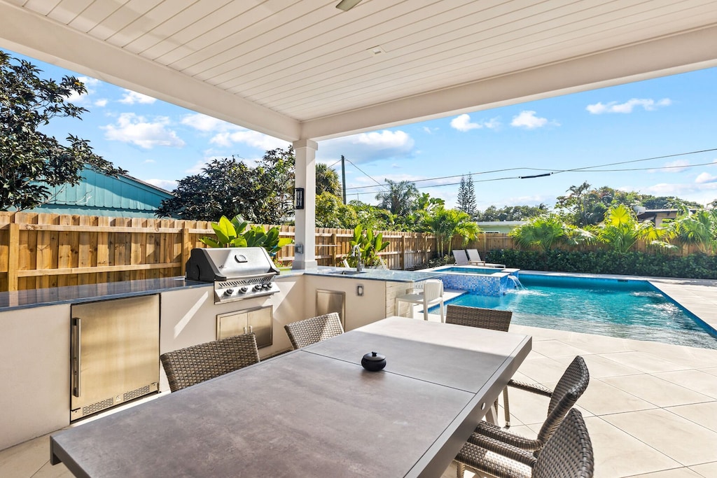 Outdoor dining with shade, fans, Florida kitchen.