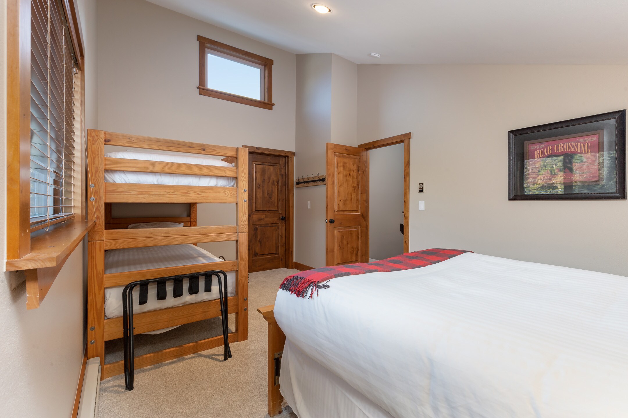The second guest bedroom is upstairs and features a queen-sized bed and a twin-sized bunk bed. 