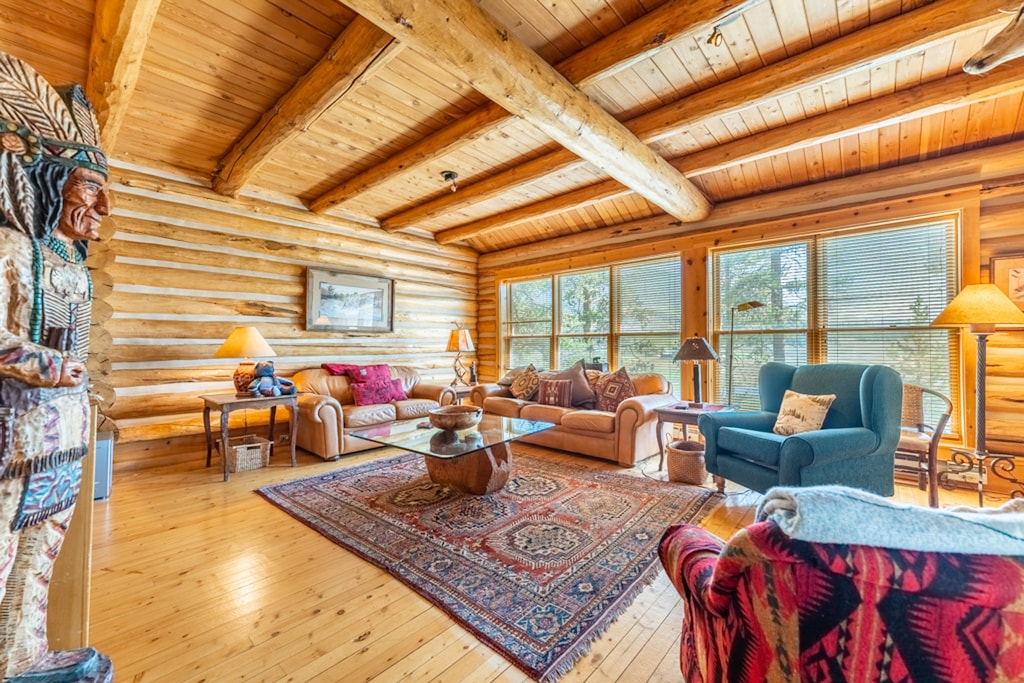 Main living area with a flat screen TV and access to the spacious deck 