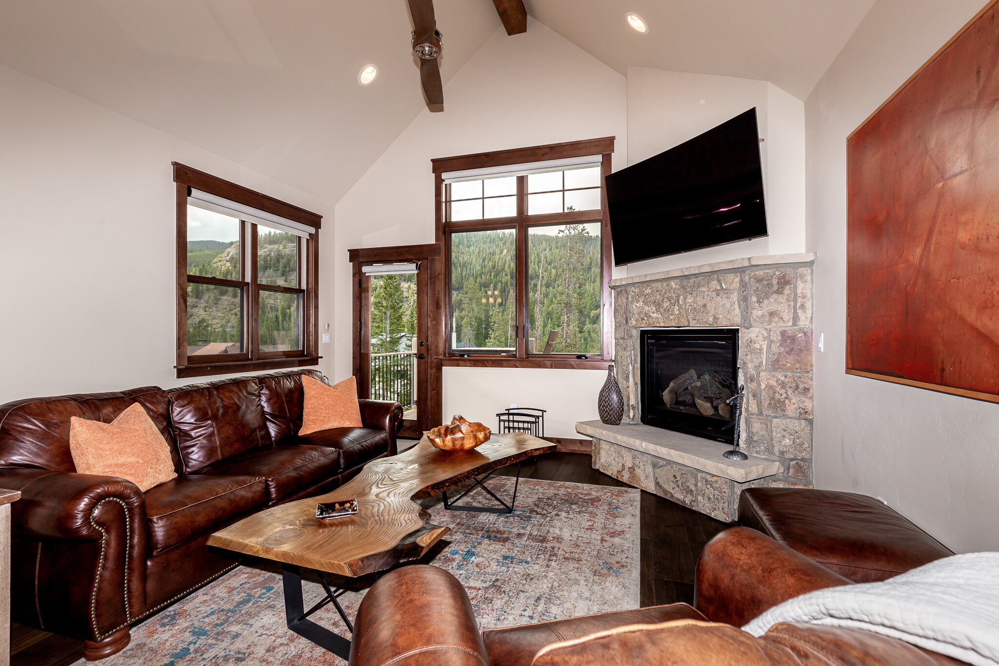 Living Room with gas fireplace, access to the private deck, and spectacular views.