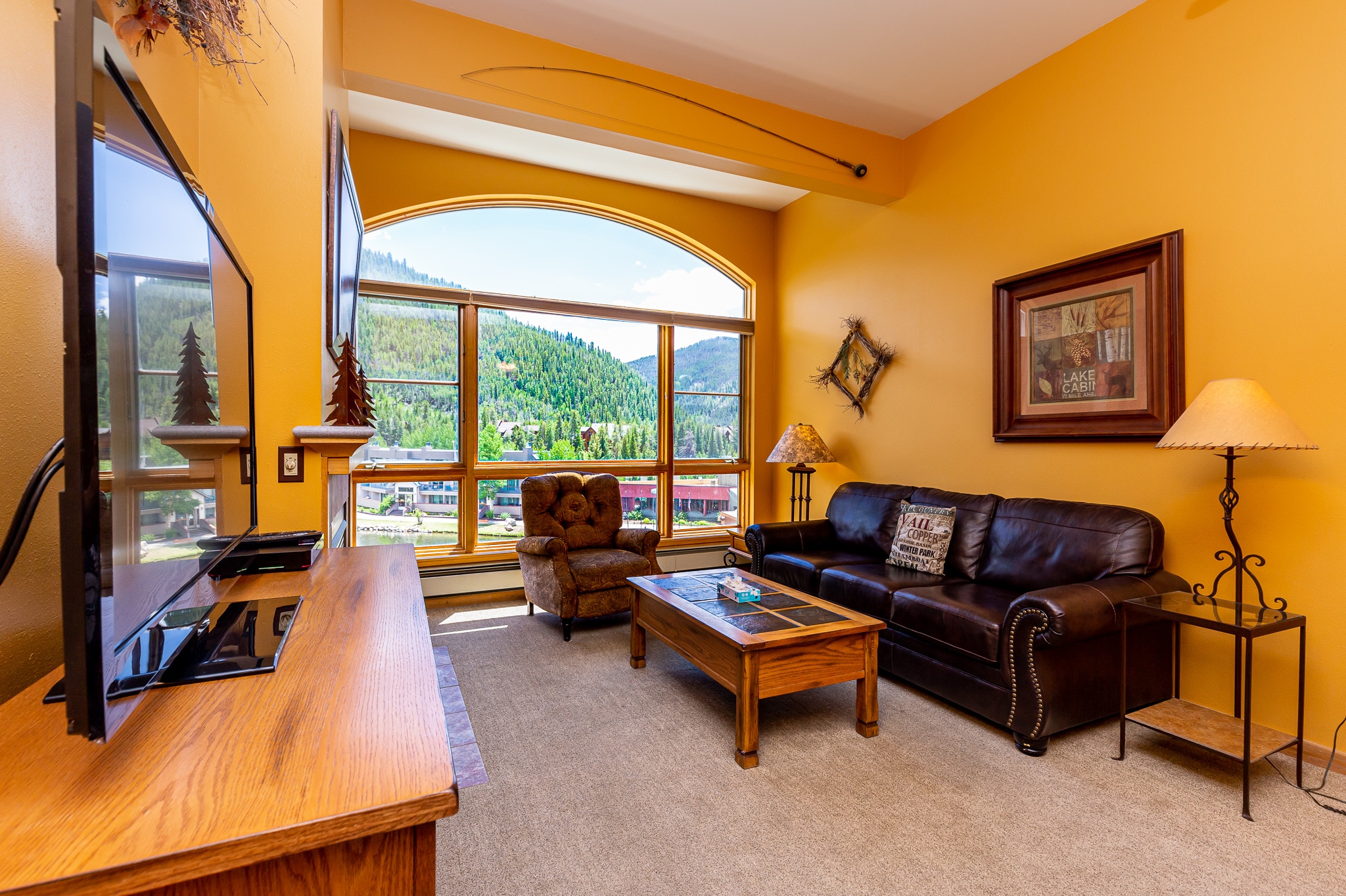 The living area features a gas fireplace, flat screen TV, and spectacular views.
