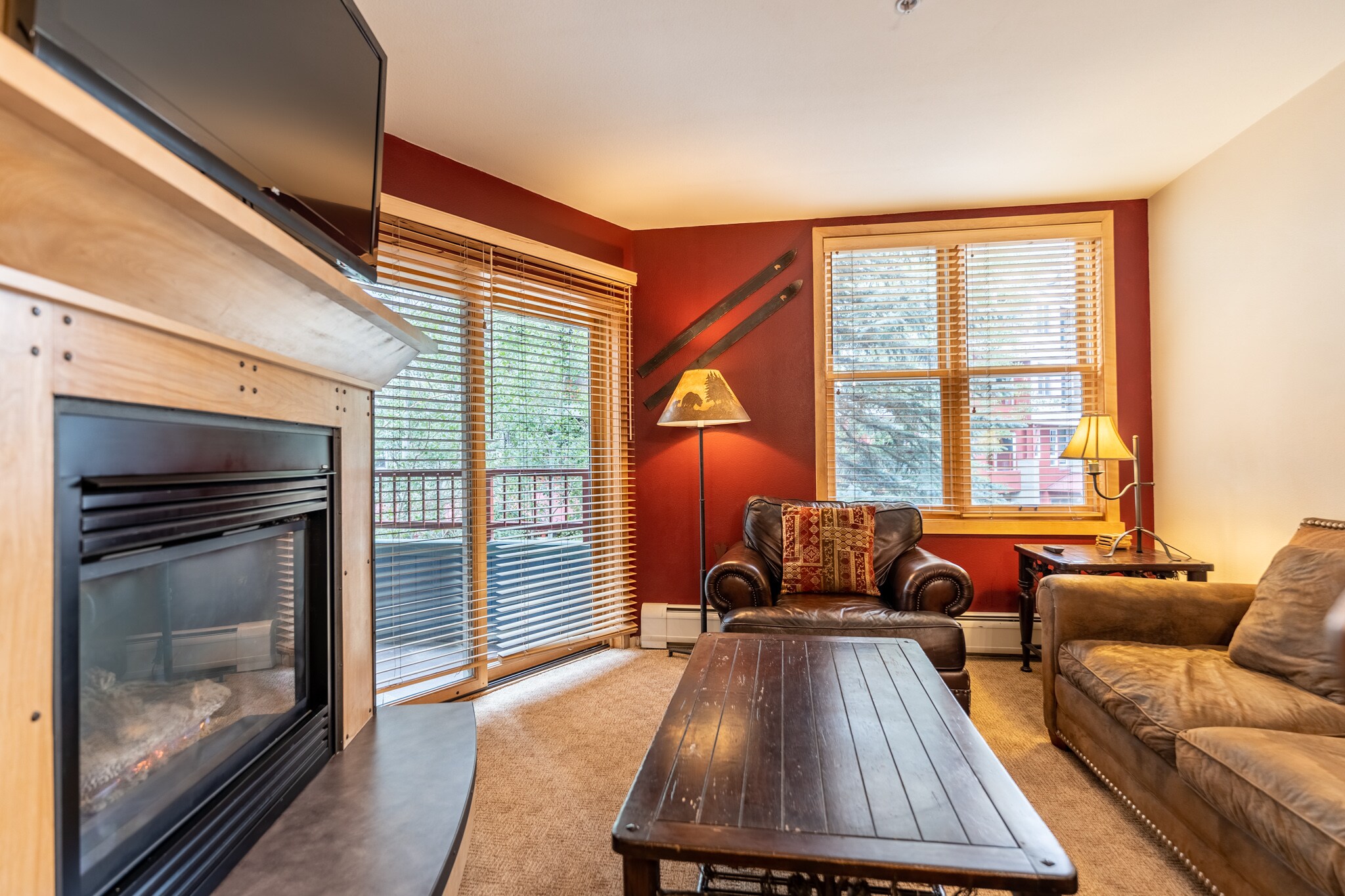 Living area featuring a gas fire place, flat screen TV, and cozy seating. 