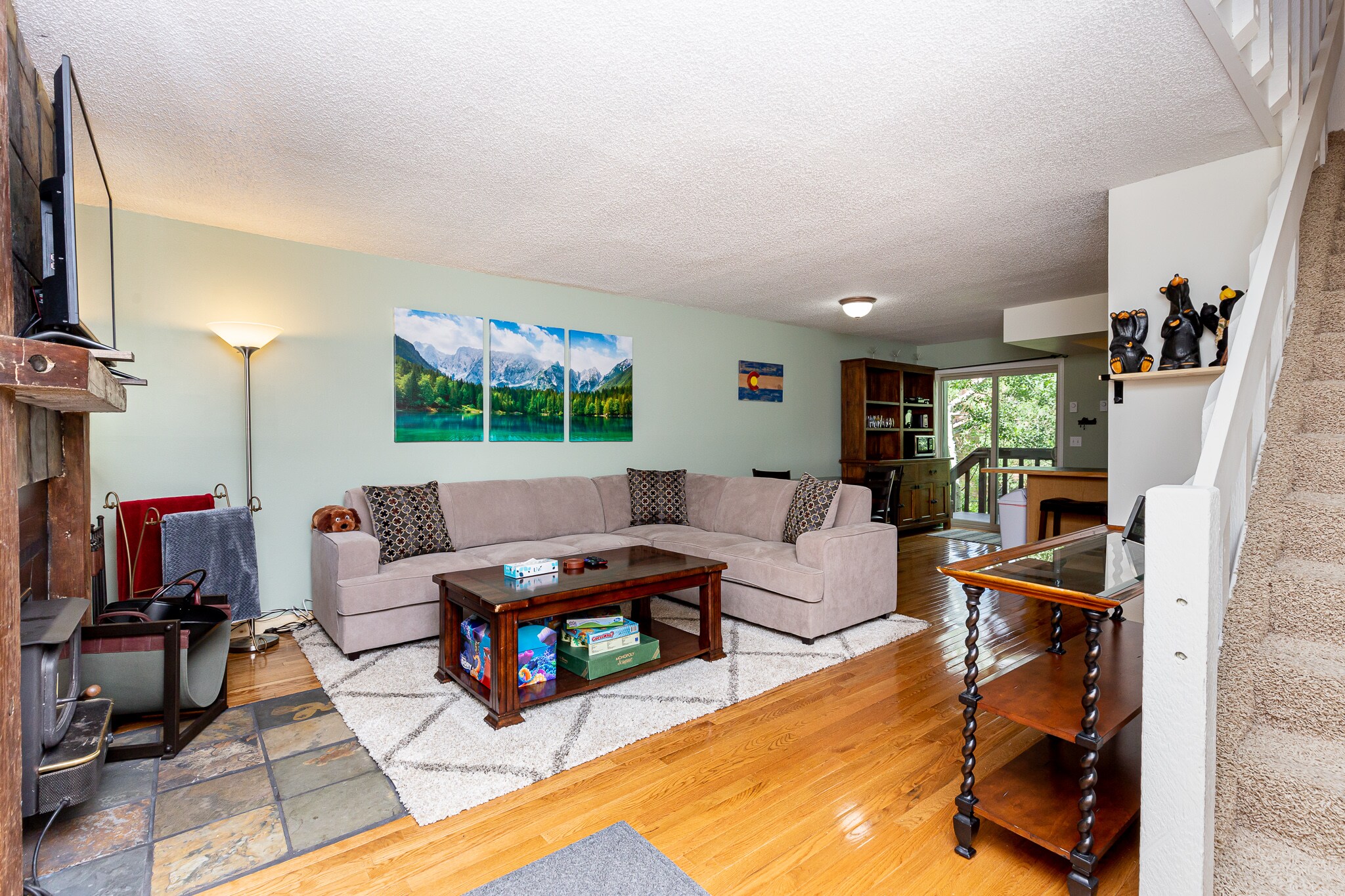 The living area features comfortable seating and a mounted flat screen TV.