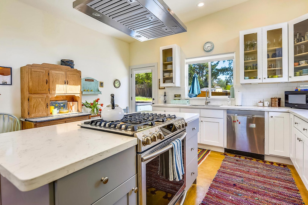 All new stainless steel appliances and ample counter space utilizing the kitchen island.