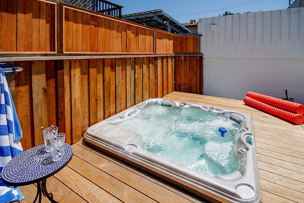The hot tub is on a raised deck for easy in and out.