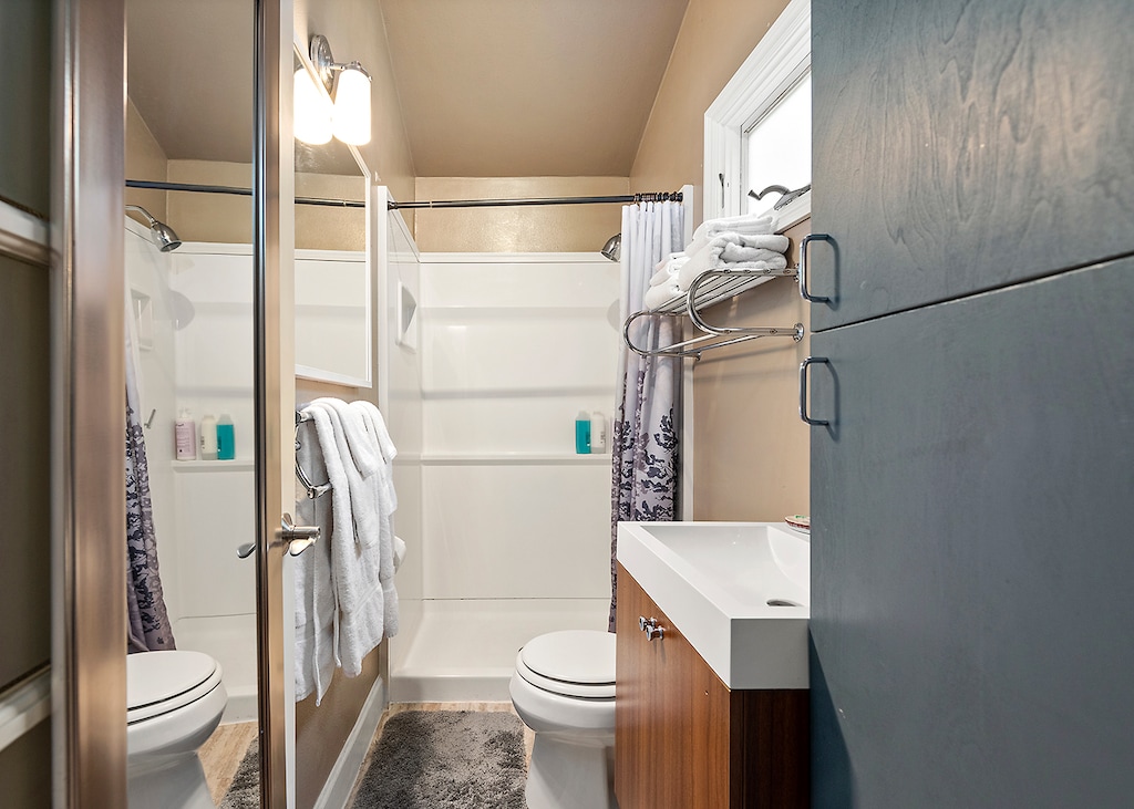 A full bathroom with shower off the hallway of the middle level.
