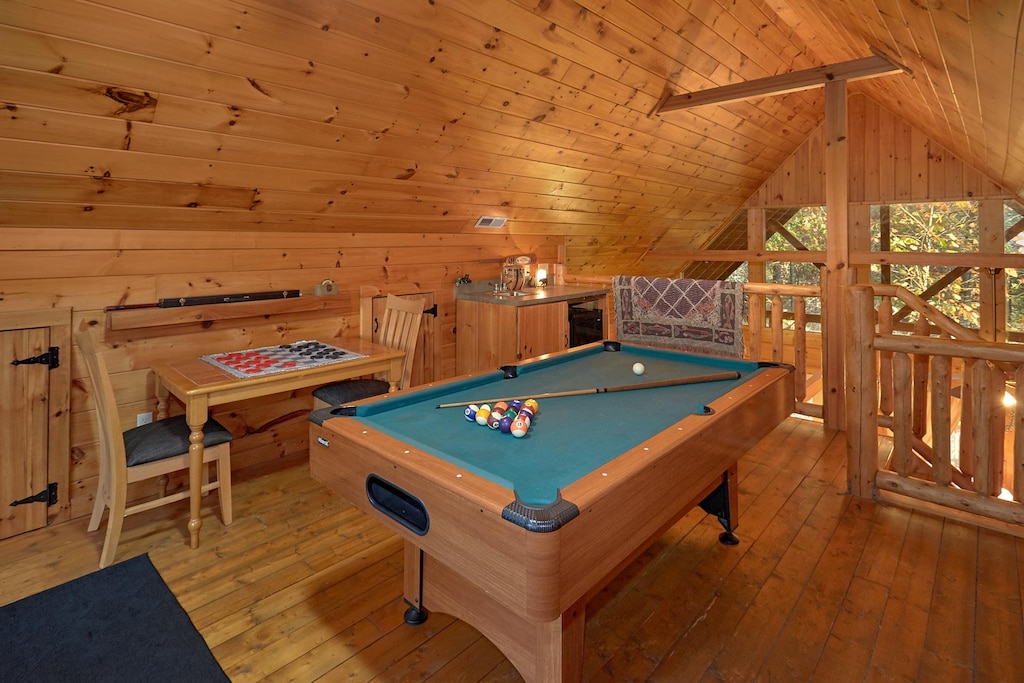 This cabin's loft area offers a futon, wet bar, game table, kid's nook, & so much more!