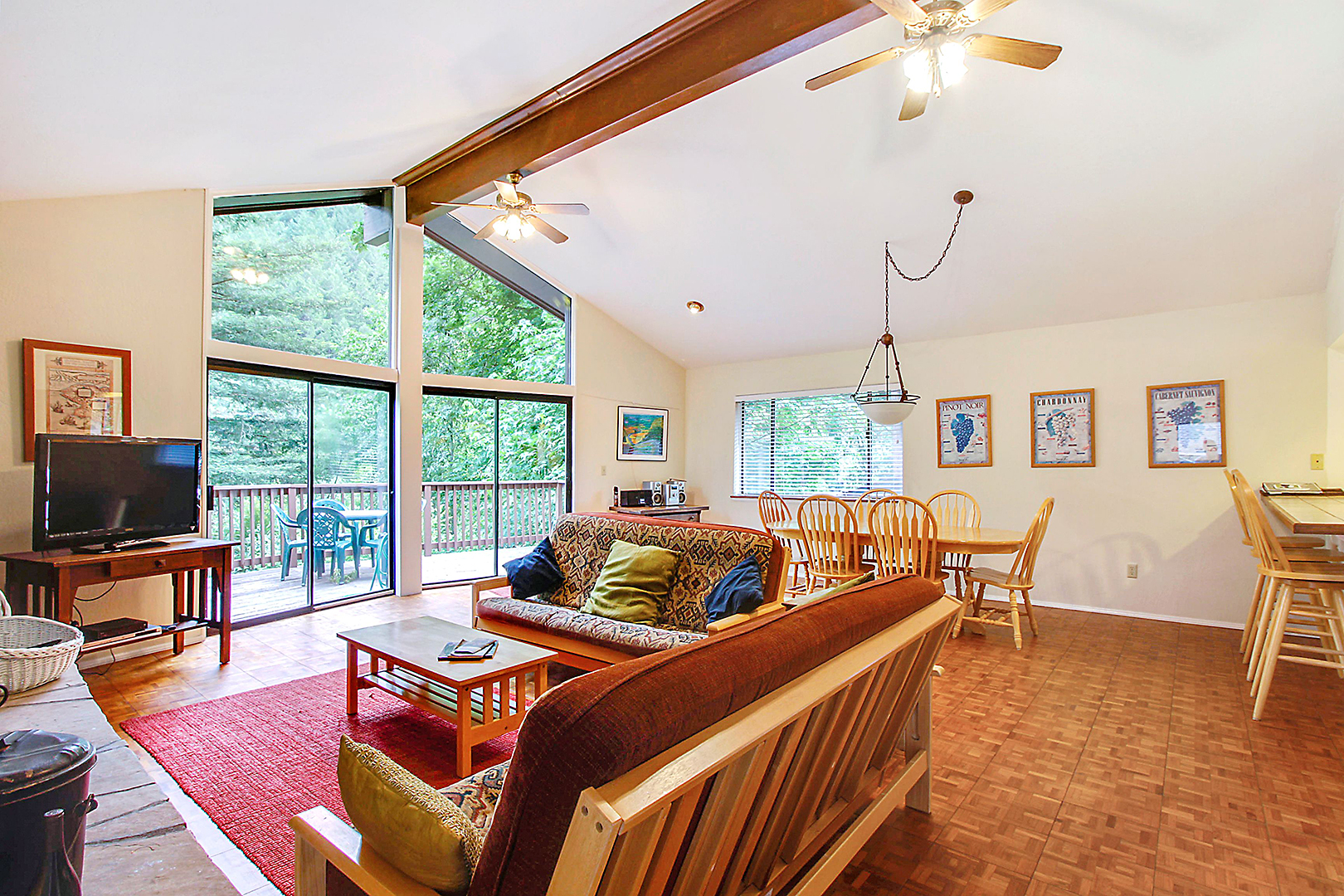 Living room with oodles of light opens to the back deck facing the river.