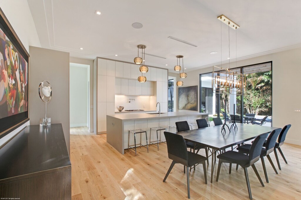 Kitchen and dining area blends seamlessly together in this modern home, equipped with everything you may need.