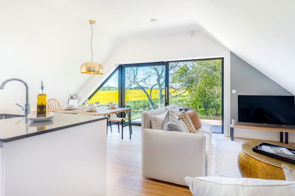 From the dining terrace, The Loft looks out on to its own private pond and rolling countryside