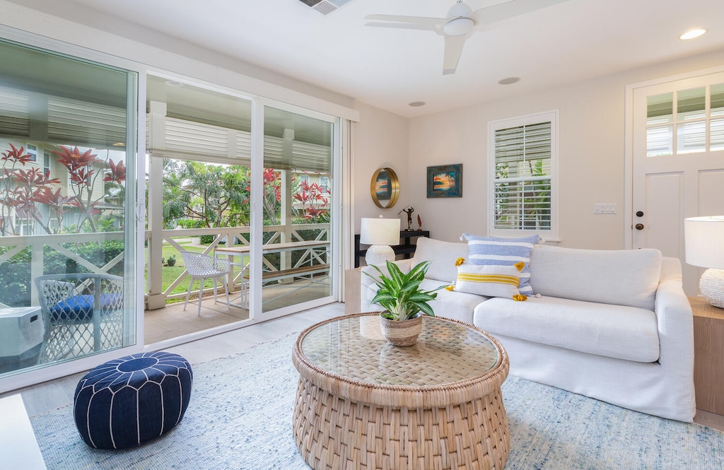 Bright living room opening to lush tropical views