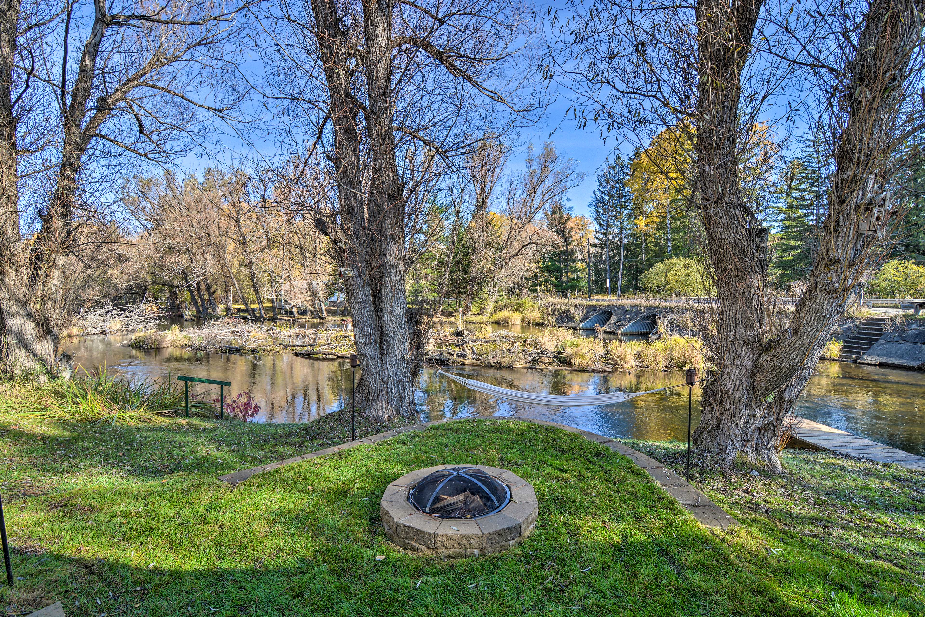 Property Image 2 - Riverfront Grayling Retreat w/ Fire Pit & Dock!